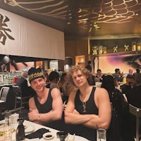 two men posing for a picture at a restaurant