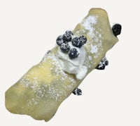 a crepe with whipped cream and blueberries