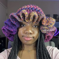 a woman wearing a crocheted ruffled hat