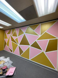 a pink and yellow painted wall in an office