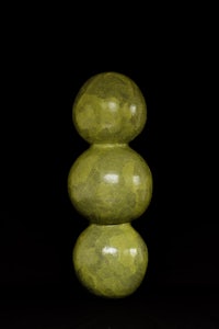 a green vase on a black background
