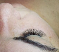 a close up of a woman's eye with long lashes