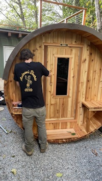 a man is putting together a wooden log cabin
