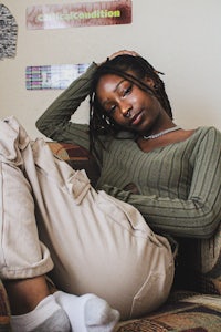 a woman with dreadlocks sitting on a couch