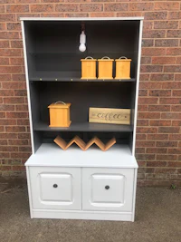 a white and grey hutch with two drawers