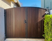 a wooden gate in front of a house
