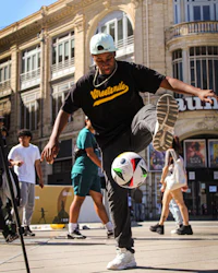 a man kicking a soccer ball