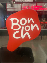 a red and white sign with the word bow wow on it