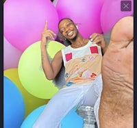 a man is posing with balloons in front of him