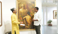 two men standing in front of a painting in an art gallery