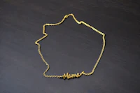 a gold necklace with the word mama on it