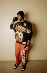a man wearing a black shirt and red pants