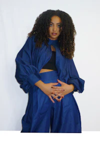 a woman in blue pants posing for a photo