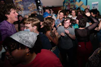 a crowd of people dancing in a room