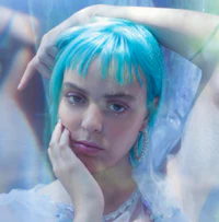 a woman with blue hair is posing for a photo