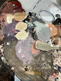 a palette with paints and brushes on it