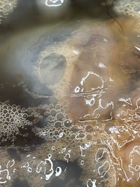 a close up of bubbles in a bowl of water