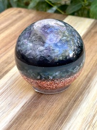 an amethyst sphere sitting on top of a wooden table