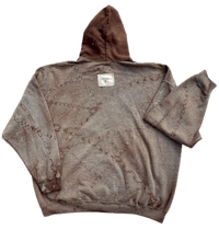 a brown hooded sweatshirt with a design on it