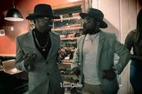 a man in a hat and a man in a suit