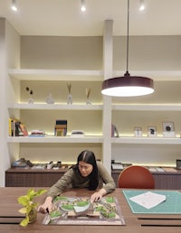 a woman is working on a puzzle in an office