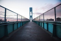 a bridge with a clock tower in the background