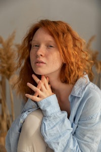 a woman with red hair posing for a photo