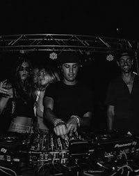 a black and white photo of a group of people at a party