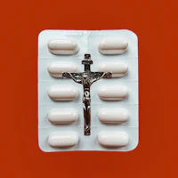 a package of pills with a crucifix on it