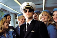 a man in a sailor's uniform posing with a group of women
