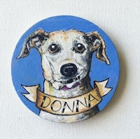 a dog with the name donna painted on a blue coaster