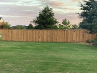 a backyard with a wooden fence