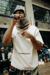 a man holding a microphone in front of a crowd