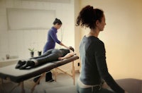 a woman is getting a massage in a room