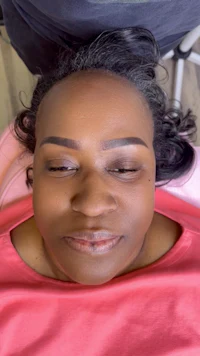 a woman laying on a bed with her eyes closed