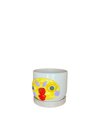 a white cup with a yellow face on it