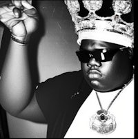 a black and white photo of a man wearing a crown