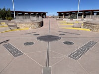 a concrete walkway with a circle in the middle of it