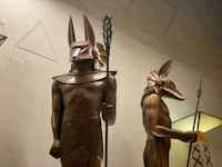 two statues of egyptian gods standing next to each other