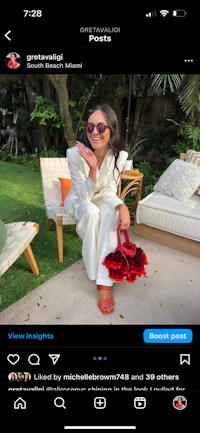 a woman is posing with a flower in her hand