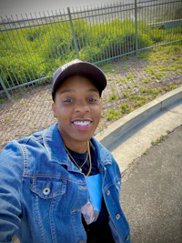 a man wearing a hat and a denim jacket