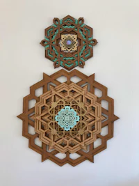 two wooden mandalas hanging on a wall