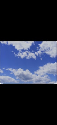 a blue sky with white clouds in the background