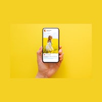 a hand holding a phone with a picture of a girl on it