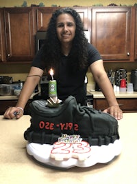 a woman holding a cake in front of her