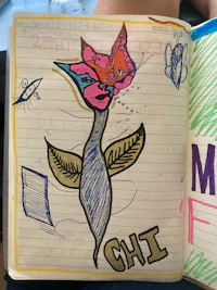an open notebook with a drawing of a hummingbird