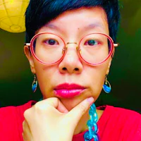 a woman wearing glasses and a necklace