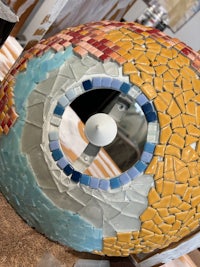 an eye made out of mosaics on a table