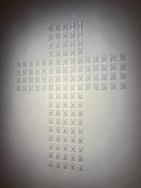 a cross made of small squares on a wall