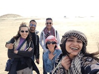 a group of people taking a selfie in the desert